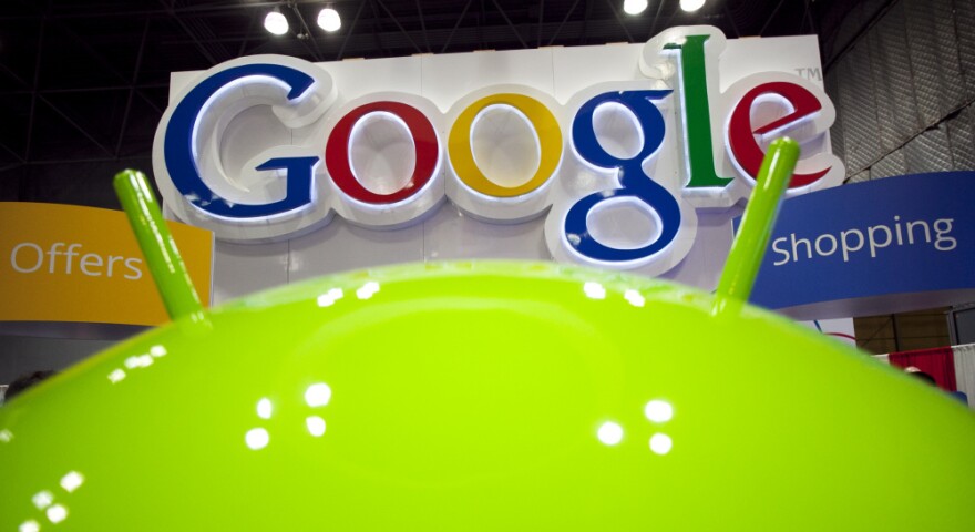 A sign for Google is displayed behind the Google Android robot at the National Retail Federation in New York. The announced changes to Google's privacy policy have drawn both positive and negative attention.