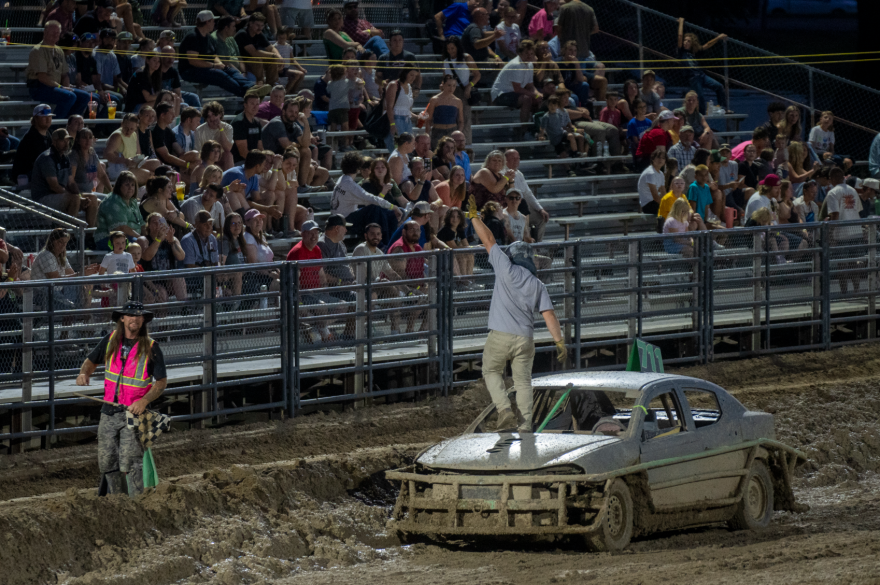 Colin Curtis stands on his car as he celebrates his win in Trash Car Racing at the Cache County Fairgrounds on Saturday, July 18, 2026.