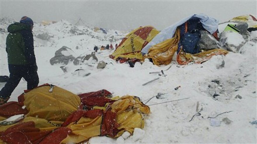 In this photo provided by Azim Afif a man approaches the scene after an avalanche triggered by a massive earthquake swept across Everest Base Camp, Nepal on Saturday, April 25, 2015. 