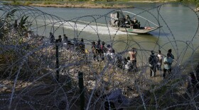 Migrants who crossed into the U.S. from Mexico are met with concertina wire along the Rio Grande, Thursday, Sept. 21, 2023, in Eagle Pass, Texas.