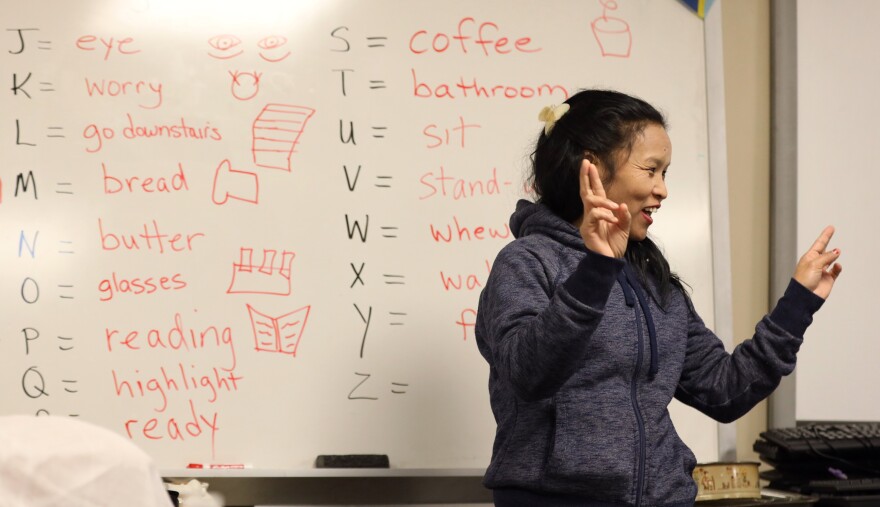 Sangita Kami reviews signs with other deaf refugee classmates at the Rochester Refugee Resettlement Services, where Deaf Refugee Advocacy operates. As a child, Sangita had no means of communication and had to work in the rice fields.