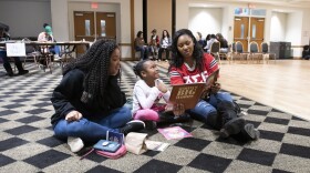 A young girl learns about Dr. Martin Luther King Jr. with her two reading buddies during the 2020 MLK Read-In in Winston-Salem. The event returns for the 14th year on Jan. 21, 2023. Photo credit: WSSU Photographer Te’Drenna Coleman.