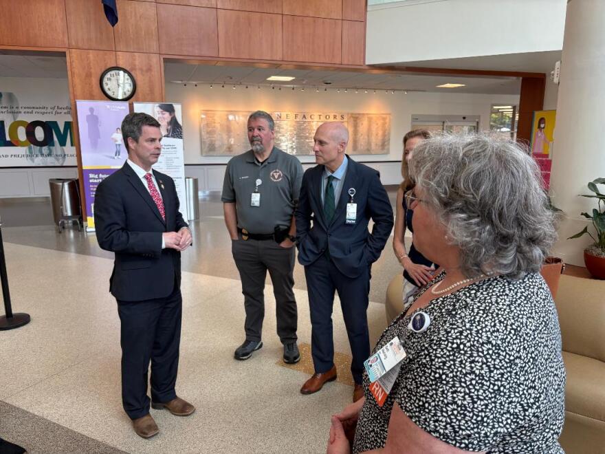 Congressman John McGuire campaigned at UVA's medical center but did not answer questions about a vote that cost constituents healthcare coverage.