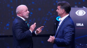 Brazilian President Luiz Inacio Lula da Silva, left, who is running for reelection, gestures as he speaks to opposition presidential candidate Sen. Flavio Bolsonaro during a televised presidential debate one week before the presidential runoff election in Sao Paulo, Brazil, Sunday, Oct. 18, 2026.