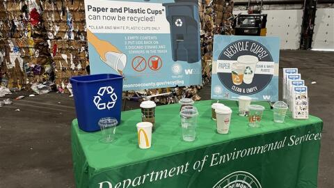 A display showing examples of cups that can now be recycled in Monroe County.