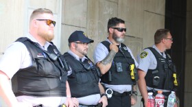 Law enforcement officers from different agencies watched as demonstrators dismantled an encampment outside local government office buildings on July 1.