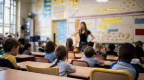 Children listen to their teacher as they sit in a classroom on the first day of the start of the school year, at the Chaptal elementary school in Paris, on September 2, 2019. (Martin Bureau/AFP via Getty Images)
