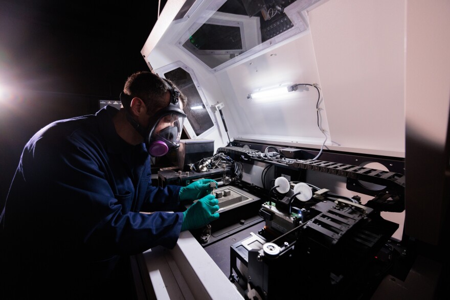 An ISU graduate student performing additive manufacturing (3D printing) research at the Quad Cities Smart Design and Manufacturing Lab in Davenport.