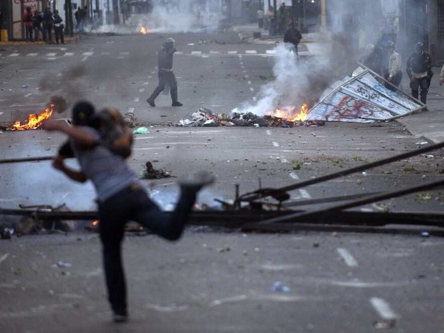 A demonstrator confronts riot policemen during an anti-government protest in Caracas, Venezuela's capital, on Feb. 22.