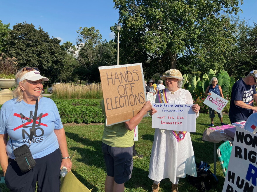 Susan Leabhart (right) held a sign Wednesday afternoon saying "Keep Faith With Our Foremothers, Fight For Our Daughters."