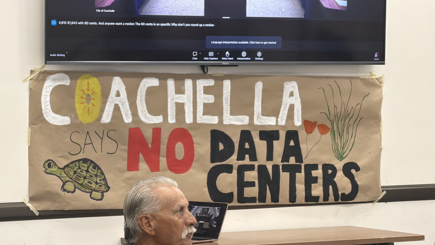 A homemade banner reads, “Coachella says no to data center” hanging on the wall of the city’s public library after the City Council meeting on Wednesday, Aug. 26, 2026. For months, residents spoke out at meetings and held protests against a proposed data center campus. Their pushback led the council to enact a permanent ban.