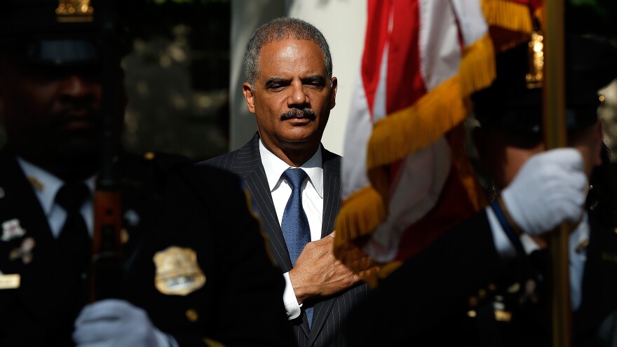 U.S. Attorney General Eric Holder attends a memorial service at the National Law Enforcement Memorial in Washington on the 13th anniversary of the Sept. 11th, 2001, attacks.