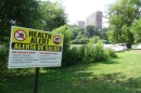 Signs warn the public to beware of the water.