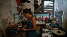 Yuneisy Riviaux prepares dinner in her kitchen in Havana, Cuba, Wednesday, March 25, 2026. (AP Photo/Ramon Espinosa)