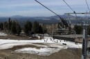 Skiers navigate a thin strip of snow at the Arizona Snowbowl near Flagstaff, Arizona on March 16, 2026. A hot, dry winter left mountains in the Colorado River Basin bereft of snow, which will strain the nation's largest reservoirs.