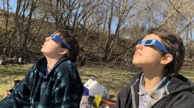 Maggie Sullivan (left) and Marty Rothenberg (right) viewing the total solar eclipse in Canaan, Vermont.