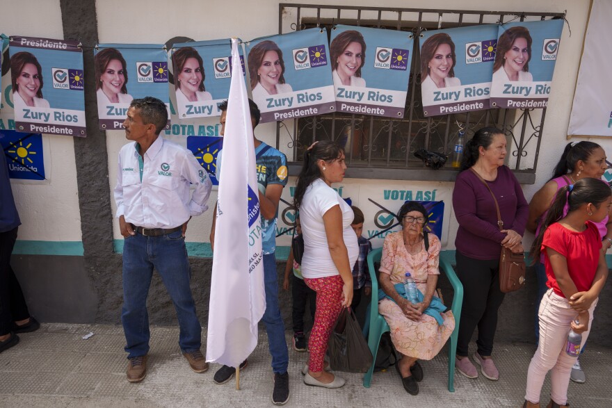 FILE - Residents wait for the start of a campaign rally promoting Zury Rios Sosa, presidential candidate for the Valor and Unionista coalition, in Sansare, Guatemala, June 2, 2023.