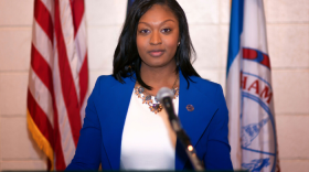 Sarah Anthony at a podium smiling 