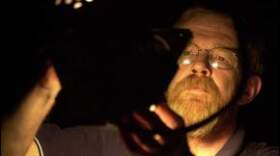 Charlie Dennis changing a stage light in 2001.