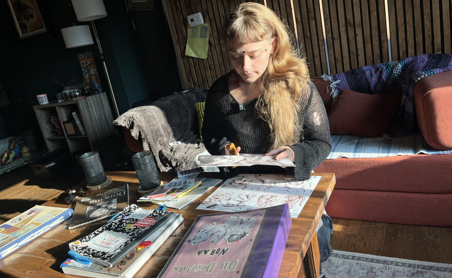 Eleanorah-Pearl Antons working on zines, mini-magazines, at her Norfolk home. The hand-crafted books have resurged in popularity, artists say, as people want to disconnect from social media and AI-generated content.