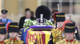 A view of the coffin of Queen Elizabeth II, adorned with a Royal Standard and the Imperial State Crown and pulled by a Gun Carriage of The King's Troop Royal Horse Artillery, during a procession from Buckingham Palace to Westminster Hall in London, Wednesday, Sept. 14, 2022. The Queen will lie in state in Westminster Hall for four full days before her funeral on Monday Sept. 19.