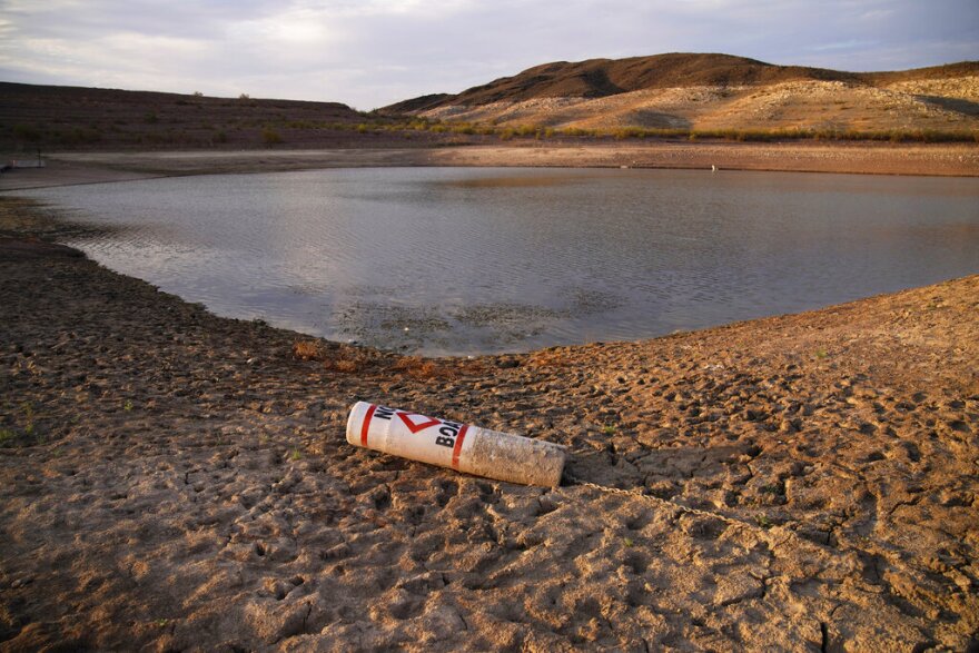 A buoy rests high and dry on the ground at a closed Lake Mead boat ramp.