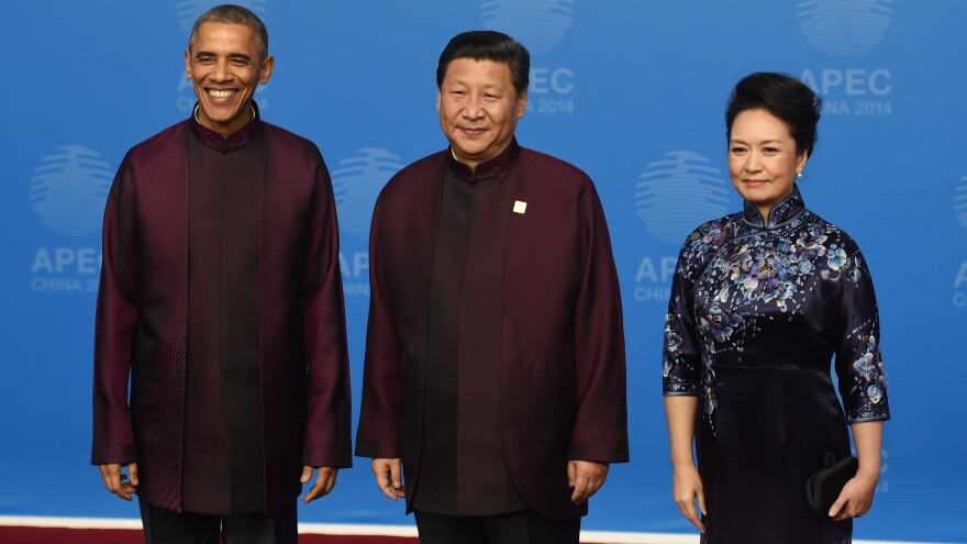 President Obama poses with Chinese President Xi Jinping and his wife, Peng Liyuan, as they arrive for the APEC banquet Monday. It's traditional for leaders attending the summit to dress alike for a photo op.