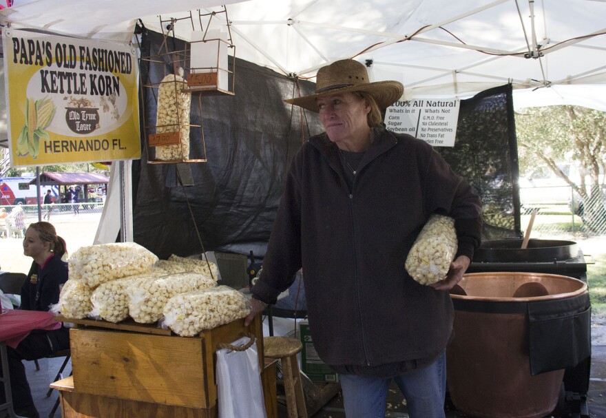 Quinn and Joe Maiocco sell organic, GMO-free, kettle corn at the Micanopy Fall festival. They have been selling at the festival for 20 years. (Ashley Leong /WUFT News)