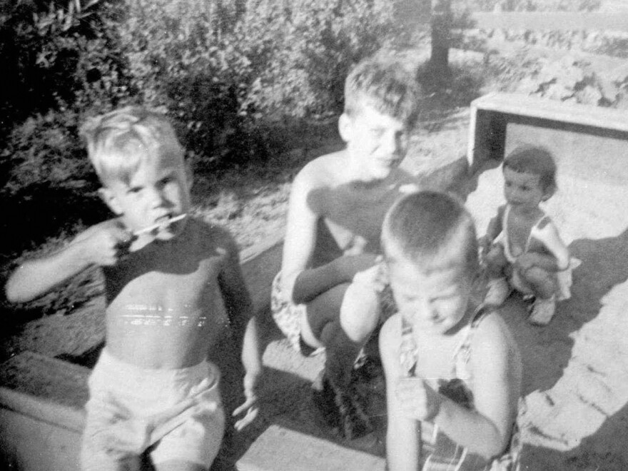 This undated family photo shows brothers David (left) and Ted Kaczynski (center) in a sandbox with neighbors.