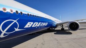 This picture shows a view of the fuselage and one of the engines of a Boeing 777-9 jetliner aircraft on the tarmac during the 2023 Dubai Airshow at Dubai World Central - Al-Maktoum International Airport in Dubai.