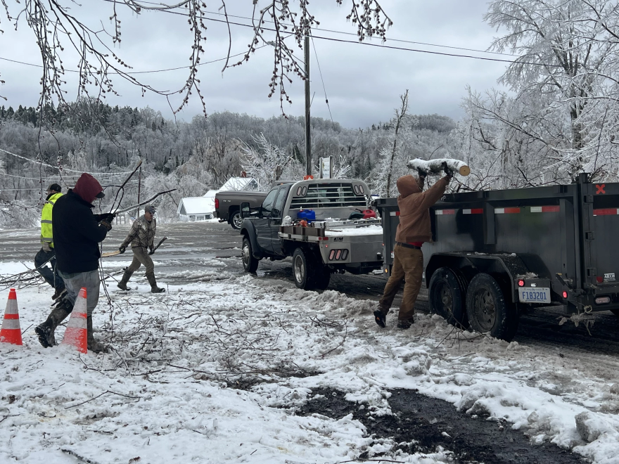 Village employees clear debris left behind by historic ice storms in Wolverine Monday, April 1.