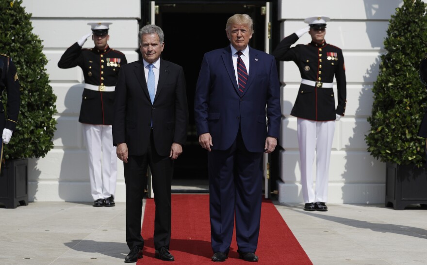 President Trump greets Finnish President Sauli Niinistö on the South Portico of the White House on Wednesday. They are holding a joint press conference amid a building impeachment inquiry into Trump.