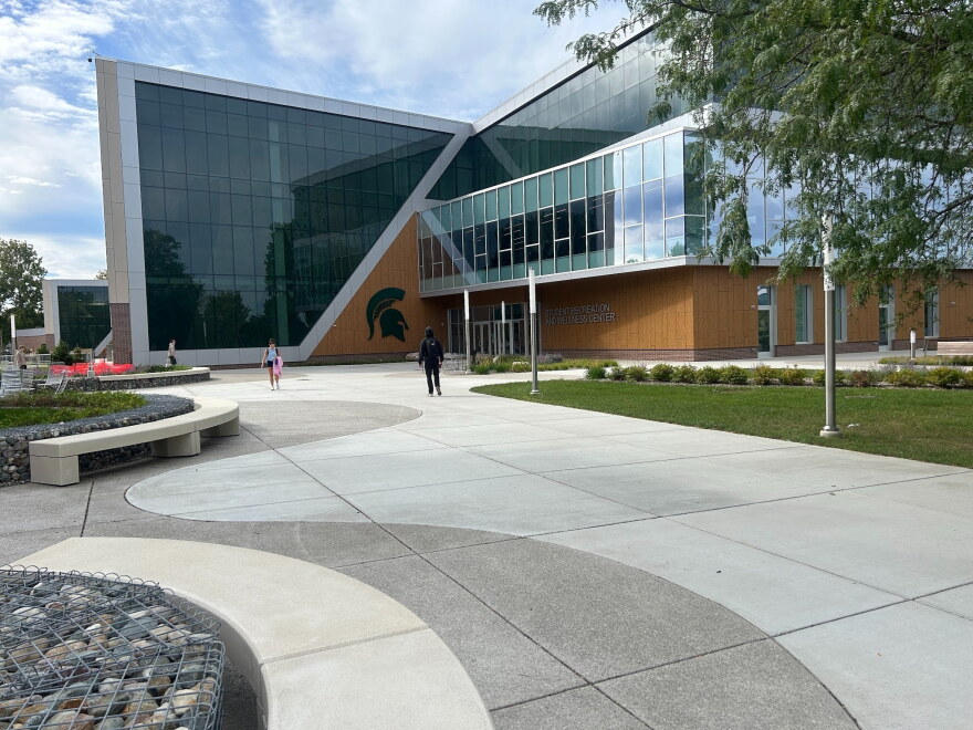 Students walk toward the Student Recreation and Wellness Center on MSU's campus.