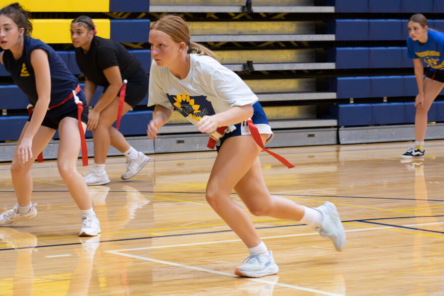 Wichita Northwest High School senior Alola Reilly runs through a drill during flag football practice at the school.