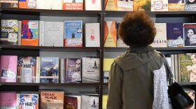 A visitor looks at books displayed at a bookshop. (Damien Meyer/AFP via Getty Images)