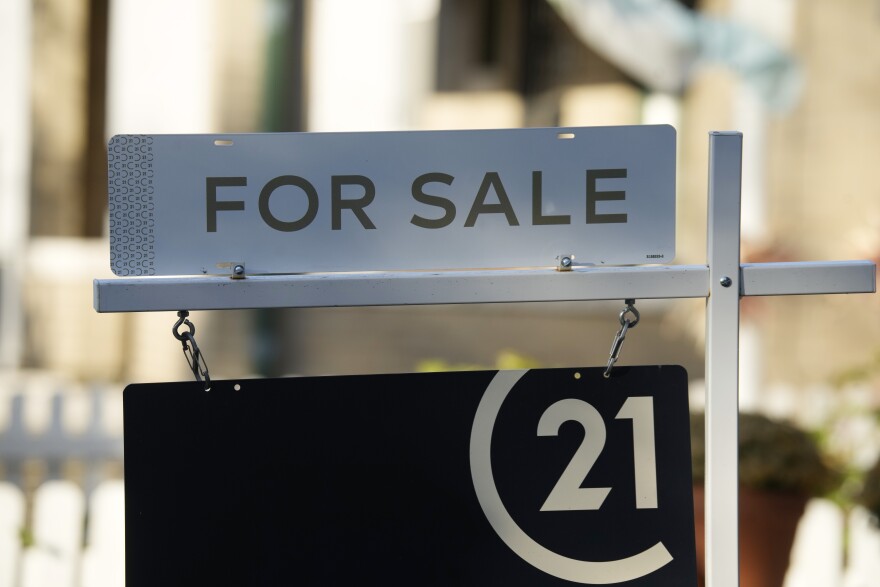 A for sale sign stands outside a single-family home on the market late Friday, Oct. 27, 2023, in Denver. 