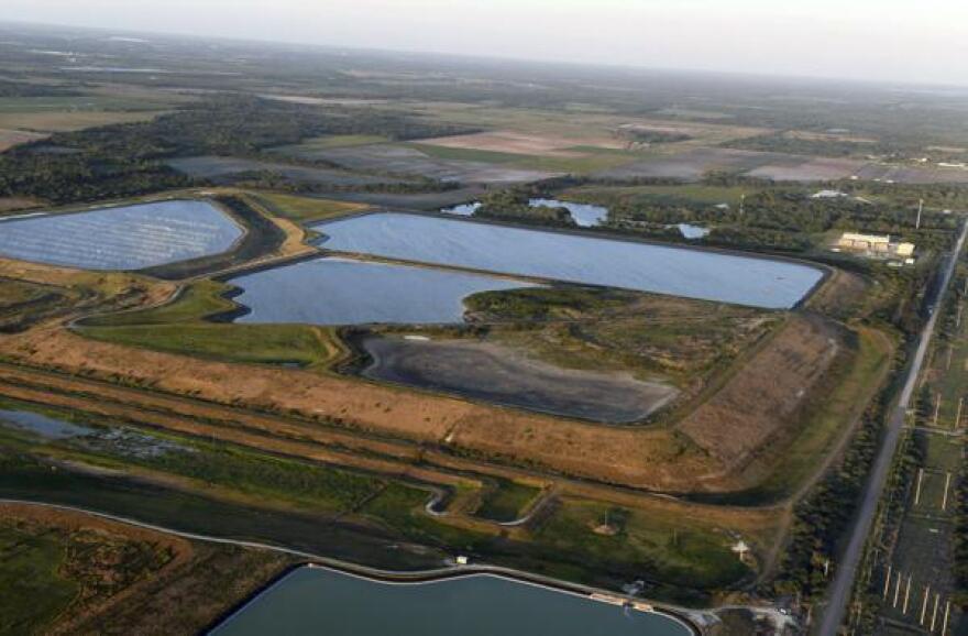 FILE - This aerial photo taken from an airplane shows a reservoir near the old Piney Point phosphate mine on April 3, 2021, in Bradenton, Fla. The polluted leftovers of Florida's phosphate fertilizer mining industry, more than 1 billion tons in “stacks” that resemble enormous ponds, are at risk for leaks or other contamination triggered by Hurricane Ian, said environmental groups Tuesday, Sept. 27, 2022. 