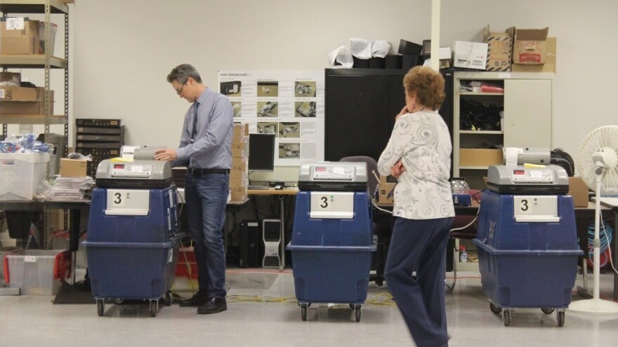 Election officials test ballot tabulation machines in Phoenix.