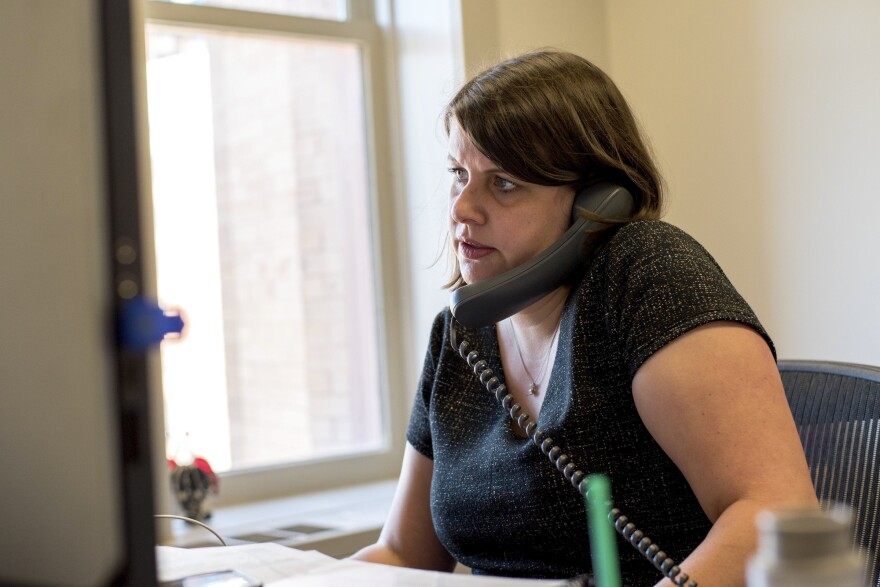 Claire Woodall-Vogg, executive director of the Milwaukee Election Commission, speaks on the phone from her office at City Hall during the partisan primary on Aug. 11, 2020.