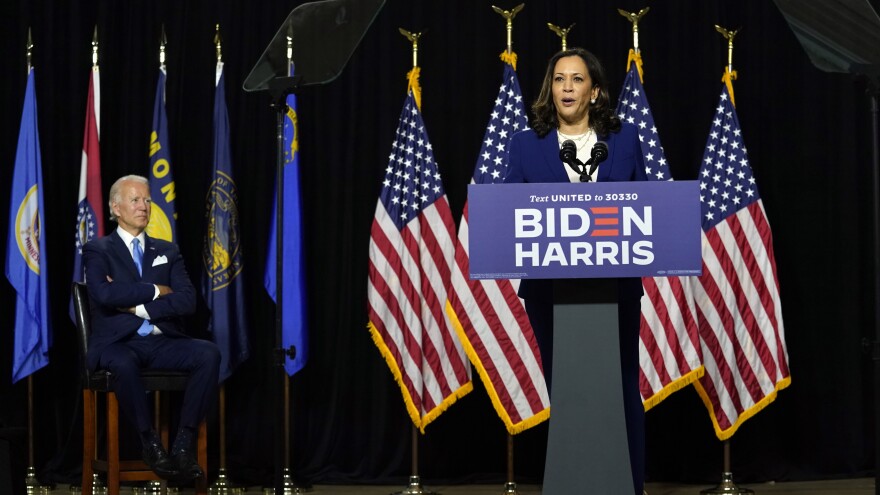 Biden listens as Harris speaks during their introductory event Wednesday at Alexis I. duPont High School.