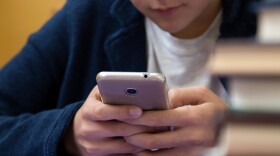 close-up of hands of the child with the mobile phone