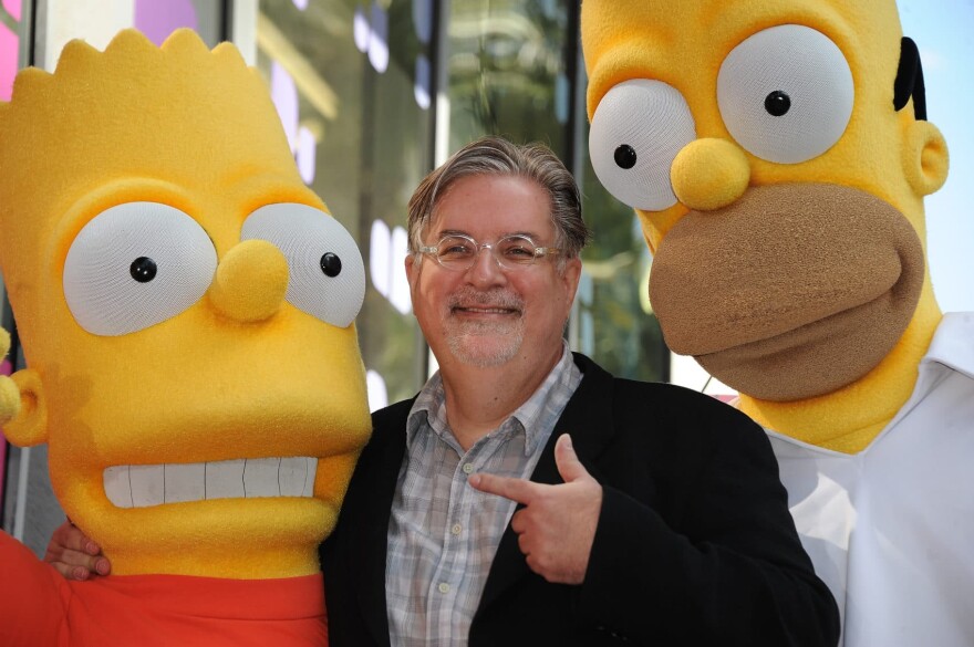 Cartoonist Matt Groening, creator of "The Simpsons," poses with his characters Bart (left) and Homer Simpson. "The Simpsons" celebrates its 30th anniversary this year. (Robyn Beck/AFP/Getty Images)