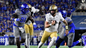 Vanderbilt quarterback Jared Curtis (2) is chased by Kentucky defensive lineman Jaden Williams (91) as he runs through an opening in the defensive line during the first half of an NCAA college football game in Lexington, Ky., Saturday, Oct. 24, 2026. (AP Photo/Timothy D. Easley)