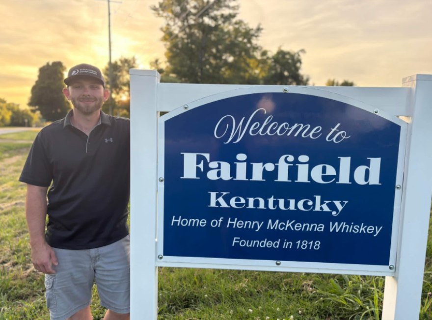 A recent photo of Herbie Hardin by the Fairfield, Kentucky sign.