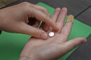 A patient prepares to take the first of two combination pills, mifepristone, for a medication abortion during a visit to a clinic in Kansas City, Kan., on, Oct. 12, 2022.