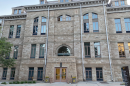 A sandstone building rises four stories above.