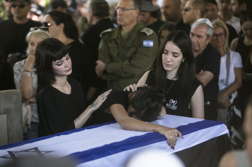 Tue., Oct. 17: Family, and friends of Yuval Solomon, who was murdered in Kfar Aaz, in Hamas' attack on the Kibbutz, mourn during his funeral in Shefayim, Israel..