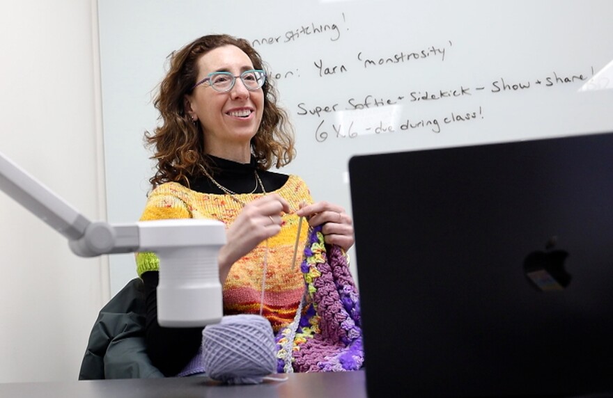 Professor Hinda Mandell crochets while lecturing and engaging students, who stitch projects together during a “Global Craftivism, Gender and Handwork” class at Rochester Institute of Technology in Rochester, N.Y.