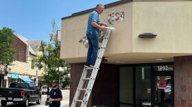 A Bank of America sign is removed from the bank's closed Roslindale branch. 