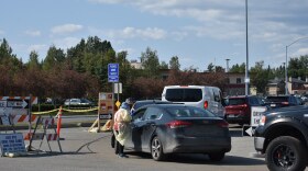 A testing center worker takes down patient information at the drive-through COVID-19 testing site on Lake Otis Parkway on July 1, 2020. (Kavitha George/Alaska Public Media)